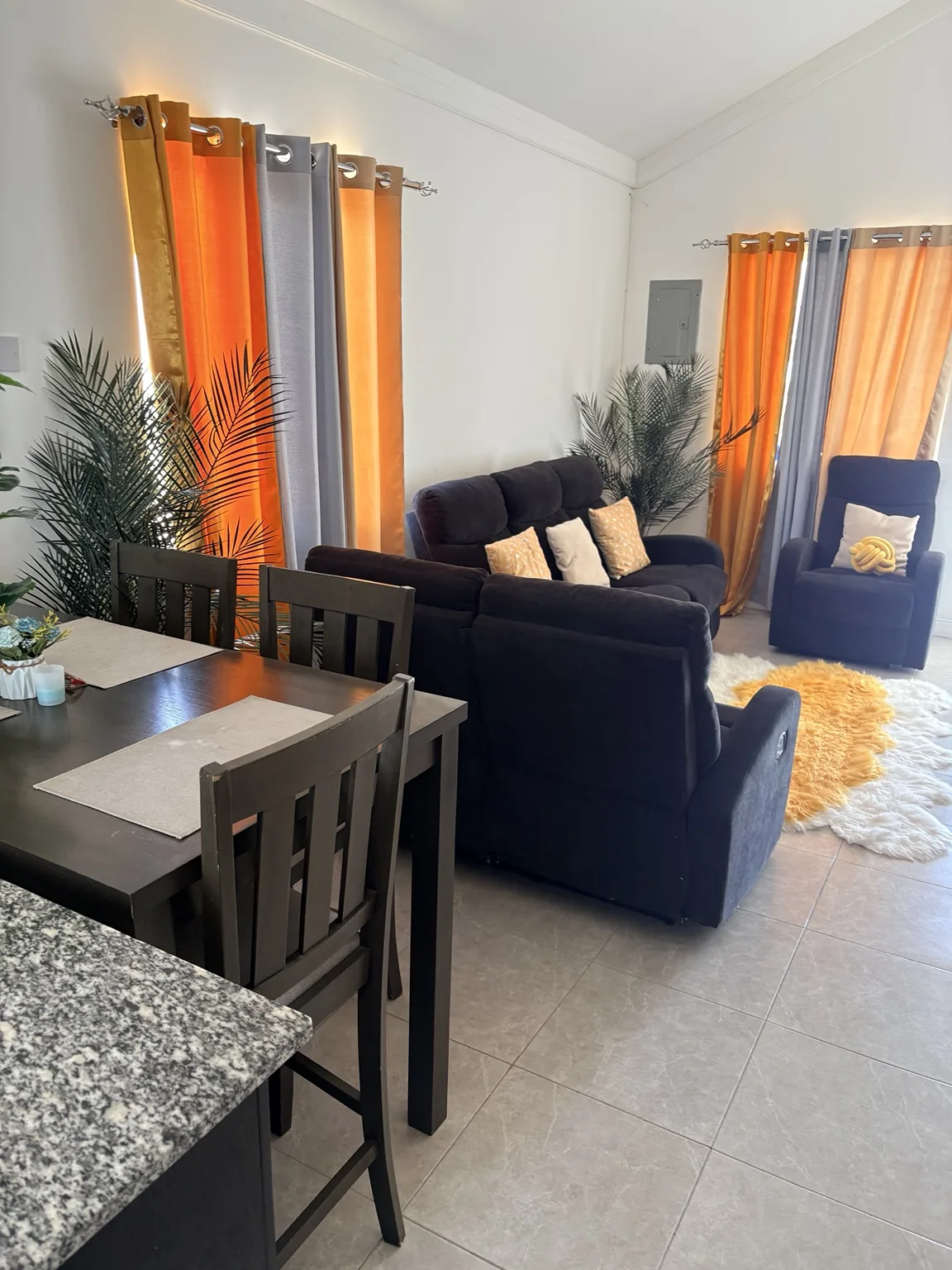 Clean living and dining area with arranged seating